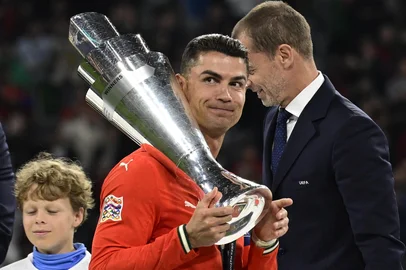 Portugal's forward #07 Cristiano Ronaldo carries the trophy after winning the UEFA Nations League final football match between Portugal and Spain in Munich, southern  on June 8, 2025. (Photo by John MACDOUGALL / AFP)<!-- NICAID(16055271) -->