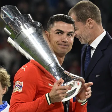 Portugal's forward #07 Cristiano Ronaldo carries the trophy after winning the UEFA Nations League final football match between Portugal and Spain in Munich, southern Germany on June 8, 2025. (Photo by John MACDOUGALL / AFP)<!-- NICAID(16055271) -->