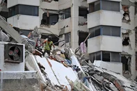 Rescue workers look from victims at a destroyed building in La Guaira, Venezuela on July 4, 2026, following the June 24 twin earthquakes. With little hope of finding loved ones alive, frustrated families of those affected by Venezuela's double earthquakes clamor for help to recover their loved one's bodies as uncertainty grows over the death toll from the tragedy. (Photo by Raul ARBOLEDA / AFP)<!-- NICAID(16320851) -->