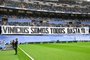A picture taken prior the Spanish league football match between Real Madrid CF and Rayo Vallecano de Madrid shows a banner reading 'We all are Vinicius. Enough (of racism)' referring to Real Madrid's Brazilian forward Vinicius Junior at the Santiago Bernabeu stadium in Madrid on May 24, 2023. Vinicius drew global support after making a stand against racist abuse he received on May 21 from Valencia supporters at their Mestalla stadium. (Photo by JAVIER SORIANO / AFP)Editoria: SPOLocal: MadridIndexador: JAVIER SORIANOSecao: soccerFonte: AFPFotógrafo: STF<!-- NICAID(15439762) -->