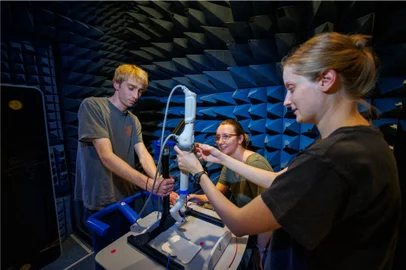 In this image courtesy of Virtual Incision's (L-R) Sean Crimmins, senior in engineering; Erika Smith, University of Nebraska Lincoln (UNL) student; and Rachael Wagner, a UNL graduate student, adjust the robotic arm on a stand in a chamber for Electromagnetic Compatibility (EMC) and Electromagnetic Interference (EMI) testing at Lincolns NCEE labs August 11, 2023, in Lincoln, Nebraska. On February 10, 2024, surgeons on Earth succeeded in controlling a small surgical robot located on the International Space Station, and remotely simulating basic techniques used during operations. This first represents a new step in the development of surgery in space, which could become necessary to treat medical emergencies during multi-year manned voyages to Mars. (Photo by Craig Chandler / Virtual Incision / AFP) / RESTRICTED TO EDITORIAL USE - MANDATORY CREDIT "AFP PHOTO / Virtual Incision, Craig Chandler / University Communications" - NO MARKETING NO ADVERTISING CAMPAIGNS - DISTRIBUTED AS A SERVICE TO CLIENTS / TO GO WITH AFP STORY by Lucie AUBOURG, "In space, a small surgical robot controlled from Earth for the first time"Editoria: SCILocal: LincolnIndexador: CRAIG CHANDLERSecao: medical specialisationFonte: Virtual IncisionFotógrafo: Handout<!-- NICAID(15679688) -->