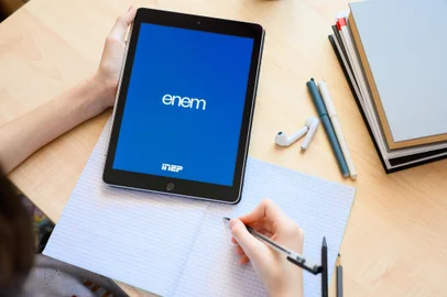 Vladimir, Russia - January 2022: A tablet in the hands of a schoolboy with an application for the ENEM exam (national high school exam)Fonte: 480696188<!-- NICAID(15891791) -->
