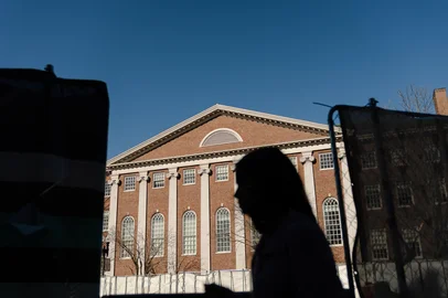 CAMBRIDGE, MASSACHUSETTS - APRIL 17: People walk past Harvard University in Harvard Square on April 17, 2025 in Cambridge, Massachusetts. The Trump administration announced that it would block Harvard University from receiving $2.2 billion in federal grants and $60 million in contracts after the school refused demands to adopt new policies relating to student and faculty conduct, admissions, anti-semitism on campus and DEI.   Sophie Park/Getty Images/AFP (Photo by Sophie Park / GETTY IMAGES NORTH AMERICA / Getty Images via AFP)<!-- NICAID(16021374) -->