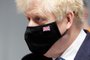 British Prime Minister Boris Johnson wears a face-mask featuring the Union Flag during a visit to Severn Trent Academy in Coventry, West Midlands on May 7, 2021. - Prime Minister Boris Johnson's Conservatives scored a stunning election victory in an opposition stronghold Friday, after Britain held its first major ballot box test since Brexit and the coronavirus crisis. (Photo by PHIL NOBLE / POOL / AFP)<!-- NICAID(14778681) -->