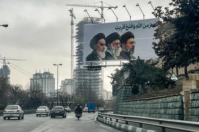 A billboard depicting Iran's supreme leaders since 1979: (L to R) Ayatollahs Ruhollah Khomeini (until 1989), Ali Khamenei (until 2026), and Mojtaba Khamenei (incumbent) is displayed above a highway in Tehran on March 10, 2026. Iran marked the appointment of Ayatollah Mojtaba Khamenei to replace his father as its supreme leader on March 9 with a new barrage of missiles against Israel and the Gulf states on Monday, as the Middle East war sent oil prices soaring. (Photo by AFP) / ATTENTION EDITORS: AFP COVERS THE WAR IN THE MIDDLE EAST THROUGH ITS EXTENSIVE REGIONAL NETWORK, INCLUDING BUREAUS IN TEHRAN, JERUSALEM, AND SEVERAL NEIGHBORING COUNTRIES. SINCE THE START OF THE CONFLICT, JOURNALISTS HAVE BEEN WORKING UNDER INCREASINGLY RESTRICTIVE CONDITIONS. AUTHORITIES IN SEVERAL COUNTRIES HAVE LIMITED REPORTERS' MOVEMENTS, PHOTO AND LIVE VIDEO COVERAGE FROM SENSITIVE LOCATIONS. SOME GOVERNMENTS AND ARMED GROUPS HAVE BANNED IMAGES OF MISSILE OR DRONE STRIKES AND OTHER SECURITY-RELATED SITES. / <!-- NICAID(16242175) -->