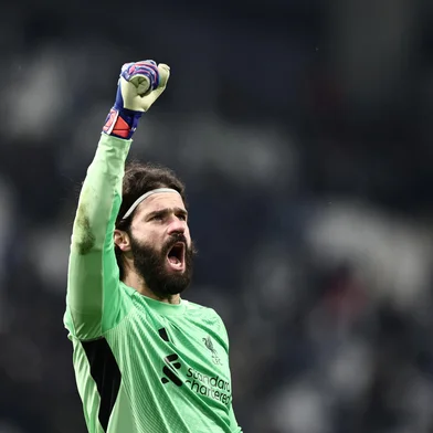 Liverpool's Brazilian goalkeeper #01 Alisson celebrates at the end of the UEFA Champions League, league phase day 7, football match between Olympique de Marseille (OM) and Liverpool FC at the Stade Velodrome in Marseille, southern France, on January 21, 2026. (Photo by Thibaud MORITZ / AFP)<!-- NICAID(16212345) -->