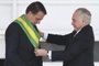 Outgoing Brazilian president Michel Temer (R), hands over the presidential sash to Brazil's new president Jair Bolsonaro at Planalto Palace in Brasilia on January 1, 2019. - Bolsonaro takes office with promises to radically change the path taken by Latin America's biggest country by trashing decades of centre-left policies. (Photo by EVARISTO SA / AFP)Editoria: POLLocal: BrasíliaIndexador: EVARISTO SASecao: governmentFonte: AFPFotógrafo: STF<!-- NICAID(13897099) -->