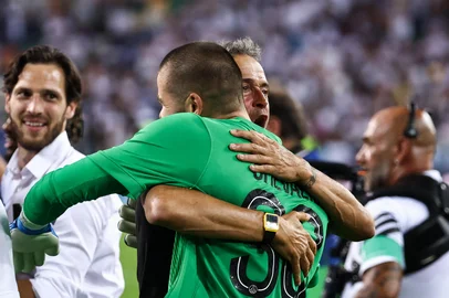 Paris Saint-Germain's Spanish headcoach Luis Enrique (C) embraces Paris Saint-Germain's French goalkeeper #30 Lucas Chevalier (R) as they celebrate winning the 2025 UEFA Super Cup final football match between Paris Saint-Germain (FRA) and Tottenham Hotspur FC (ENG) at the Friuli stadium, in Udine, on August 13, 2025. (Photo by FRANCK FIFE / AFP)<!-- NICAID(16100953) -->