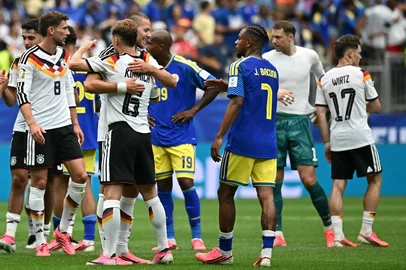 Germany's defender #15 Nico Schlotterbeck (C) celebrates with Germany's defender #18 Nathaniel Brown (L) after scoring his team's second goal  during the 2026 World Cup Group E football match between Germany and Curacao at the Houston Stadium in Houston on June 14, 2026.  (Photo by RONALDO SCHEMIDT / AFP)<!-- NICAID(16306107) -->