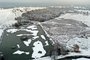 An aerial view shows a frozen lake, with areas covered in snow in Richmond Park, south west London on December 12, 2022. (Photo by Daniel LEAL / AFP)<!-- NICAID(15293453) -->