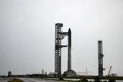 SpaceX's new Starship V3 rocket is seen docked at the Starbase during the 12th test flight on May 21, 2026 as seen from South Padre Island in Texas. Elon Musk's SpaceX is set for the debut launch of its latest Starship iteration on Thursday, testing the most powerful version yet of the megarocket as the company targets a blockbuster initial public offering. (Photo by RONALDO SCHEMIDT / AFP)<!-- NICAID(16291002) -->