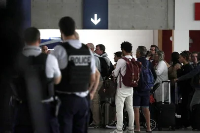 People arrive at Paris Roissy Charles de Gaulle airport in Roissy-en-France, near Paris on August 2, 2023, after being evacuated from Niger. The first of three planes carrying mostly French and European people evacuated from Niger landed in Paris early Wednesday, a week after a coup toppled one of the last pro-Western leaders in the jihadist-plagued Sahel. "There are 262 people on board the plane, an Airbus A330, including a dozen babies," French Foreign Minister Catherine Colonna told AFP before the flight landed at Paris Roissy Charles de Gaulle airport. (Photo by Lou Benoist / AFP)<!-- NICAID(15498557) -->
