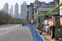 This photo taken on March 17, 2020 shows a barrier set up to prevent people from entering or leaving a residential community in Wuhan, in China's central Hubei province. - After Wuhan and its 11 million people were placed under strict quarantine on January 23 to control the spread of the COVID-19 coronavirus, a network of physical barriers have divided the city - some more official than others. (Photo by STR / AFP) / China OUT