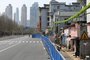 This photo taken on March 17, 2020 shows a barrier set up to prevent people from entering or leaving a residential community in Wuhan, in China's central Hubei province. - After Wuhan and its 11 million people were placed under strict quarantine on January 23 to control the spread of the COVID-19 coronavirus, a network of physical barriers have divided the city - some more official than others. (Photo by STR / AFP) / China OUT
