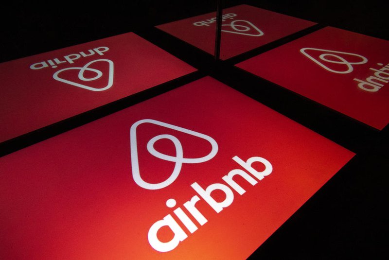 (FILES) In this file illustration photo taken on November 22, 2019 shows the logo of the online lodging service Airbnb displayed on a tablet in Paris. - Home-sharing giant Airbnb, which is scheduled to go public this week, will significantly raise its IPO price, valuing the group at more than $40 billion, the Wall Street Journal reported on December 6, 2020. (Photo by Lionel BONAVENTURE / AFP)<!-- NICAID(14662850) -->
