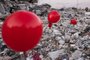 This photograph taken on February 21, 2023 shows ballons hanging on the rubble of a collapsed building in Antakya, southern Turkey, following the 6.4-magnitude earthquake which struck on February 20, two weeks after a 7.8-magnitude earthquake hit near Gaziantep and has killed more than 44,000 people. - On the side of a busy road in Antakya, dozens of red balloons flutter around, hanging from the ruins. They are "the last toys" of children who died during the earthquake that devastated this southern Turkish city, explains Ogun Sever Okur, the author of this posthumous gift. (Photo by Sameer Al-DOUMY / AFP)<!-- NICAID(15356444) -->