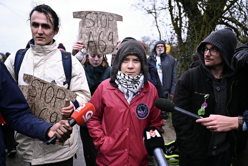 Swedish environmental activist Greta Thunberg and protesters take part in a demonstration against the A69 motorway project between Toulouse and Castres, in Saix, southwestern France, on February 10, 2024. French gendarmes conducted an intervention on February 9, to clear an area near the planned motorway after activists had set up camp toilets and signposts on private land where they planned to create a so-called "zone to be defended" (ZAD) camp dubbed "CremArbre". Police cleared pallets and trolleys used to block a small road running alongside the field, which is close to the route of the planned A69 motorway linking Toulouse and the town of Castres. (Photo by Lionel BONAVENTURE / AFP)<!-- NICAID(15675769) -->