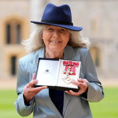 (FILES) British author Jilly Cooper poses with the medal and insignia after being appointed a Dame Commander of the Order of the British Empire (DBE) following an investiture ceremony at Windsor Castle, southern England, on May 14, 2024. Author Dame Jilly Cooper has died at the age of 88, a spokesperson has said, October 6. (Photo by Andrew Matthews / POOL / AFP)<!-- NICAID(16140623) -->