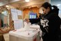 A woman casts her ballot in Russia's presidential election at a polling station in Moscow on March 17, 2024. (Photo by STRINGER / AFP)<!-- NICAID(15707739) -->