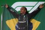 Mercedes' British driver Lewis Hamilton drinks champagne while celebrating on the podium after winning Brazil's Formula One Sao Paulo Grand Prix at the Autodromo Jose Carlos Pace, or Interlagos racetrack, in Sao Paulo, on November 14, 2021. (Photo by CARL DE SOUZA / AFP)Editoria: SPOLocal: Sao PauloIndexador: CARL DE SOUZASecao: motor racingFonte: AFPFotógrafo: STF<!-- NICAID(14940868) -->