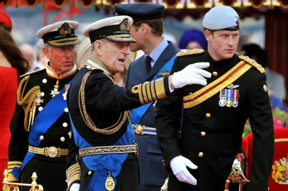 (FILES) In this file photo taken on June 03, 2012 Members of the Royal family (from left to right) Prince Charles, Prince of Wales, Prince Philip, Duke of Edinburgh, Prince William and Prince Harry talk onboard the Spirit of Chartwell during the Thames Diamond Jubilee Pageant on the River Thames in London. - Queen Elizabeth II's 99-year-old husband Prince Philip, who was recently hospitalised and underwent a successful heart procedure, died on April 9, 2021, Buckingham Palace announced. (Photo by JOHN STILLWELL / POOL / AFP)<!-- NICAID(14758356) -->