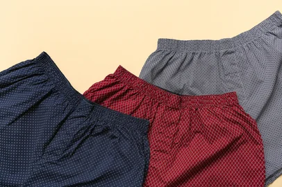 Stylish male trunks on beige background<!-- NICAID(15987847) -->