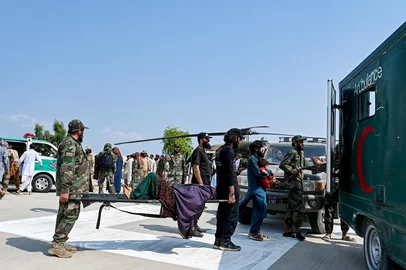 Taliban security personnel carry an earthquake victim evacuated by a military helicopter from the Nurgal district of Kunar province, to an ambulance after her arrival in Jalalabad on September 1, 2025. A massive rescue operation was underway in Afghanistan on September 1, after a strong earthquake and multiple aftershocks flattened homes in a remote, mountainous region, killing more than 800 people, the Taliban authorities said. (Photo by Wakil KOHSAR / AFP)<!-- NICAID(16114198) -->