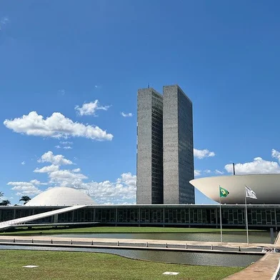 Fachada do Congresso NacionalFachada do Palácio do Congresso Nacional. O Palácio do Congresso Nacional é um dos pilares da arquitetura monumental de Niemeyer que dão forma à capital inaugurada em 1960. Construído em terreno elevado, é visto de longe como culminância da avenida Eixo Monumental, que abriga a Esplanada dos Ministérios e atravessa a cidade de norte a sul. Sede das duas Casas do Poder Legislativo e um dos mais famosos cartões postais do Brasil, o Palácio do Congresso Nacional é composto por duas cúpulas e duas torres de 28 andares, que abrigam a Câmara dos Deputados e o Senado Federal.Foto: Leonardo Sá/Agência Senado
