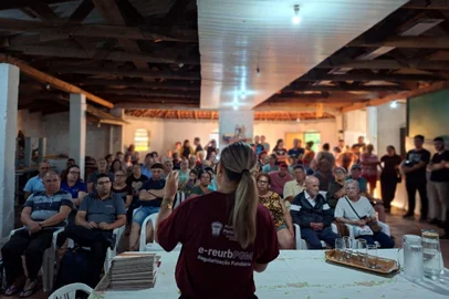 PORTO ALEGRE, RS, BRASIL - 18/12/2025 - Entrega de títulos de regularização fundiária em Porto Alegre (Igor Chaves/Divulgação)<!-- NICAID(16190209) -->