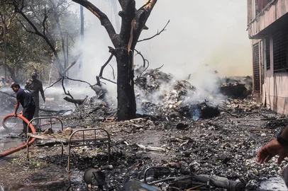 Firefighters work at the site where Air India flight 171 crashed in a residential area near the airport in Ahmedabad on June 12, 2025. The London-bound passenger plane crashed on June 12 in India's western city of Ahmedabad with 242 on board, aviation officials said in what the airline called a "tragic accident". (Photo by Sam PANTHAKY / AFP)<!-- NICAID(16057933) -->