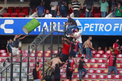 Supporters of Atlas fight with supporters of Queretaro during the Mexican Clausura tournament football match between Queretaro and Atlas at Corregidora stadium in Queretaro, Mexico on March 5, 2022. - A match between Mexican football clubs was called off March 5, 2022 after violence by opposing fans spilled onto the field. The game between Queretaro and Atlas at La Corregidora stadium in the city of Queretaro  -- the ninth round of the 2022 Clausura football tournament -- was in its 63rd minute when fights between opposing fans broke out. (Photo by EDUARDO GOMEZ / AFP)Editoria: SPOLocal: QuerétaroIndexador: EDUARDO GOMEZSecao: soccerFonte: AFPFotógrafo: STR<!-- NICAID(15034276) -->