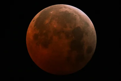 The full moon, also known as the "Blood Moon," is seen in San Salvador, El Salvador on March 14, 2025, during a lunar eclipse. Stargazers across a swathe of the world marvelled at a dramatic red "Blood Moon" during a rare total lunar eclipse in the early hours of March 14. (Photo by Marvin RECINOS / AFP)<!-- NICAID(15995353) -->