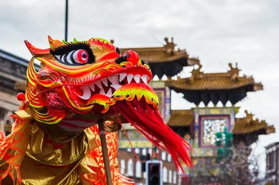 The pretty orange and red coloured dragon weaves through the crowds of people in Liverpool's Chinatown chasing a pearl during Chinese New Year celebrations.<!-- NICAID(15974078) -->