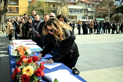 A woman signs a book of condolences in Kocani on March 17, 2025, a day after a fire tore through an overcrowded nightclub packed with mostly young people in North Macedonia killing 59 revellers. A fire tore through an overcrowded nightclub packed with mostly young people in North Macedonia early on March 16, 2025, killing 59 people, apparently after on-stage fireworks at a hip-hop concert set the venue ablaze, authorities said. Some 155 people who were injured in the inferno had been taken to hospitals across the country, 22 of them in critical condition, officials said. (Photo by Robert ATANASOVSKI / AFP)<!-- NICAID(15997113) -->