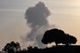 A picture taken from the southern Israeli city of Sderot on October 26, 2023 shows smoke rising from the Gaza Strip during an Israeli strike, amid ongoing battles between Israel and the Palestinian Hamas movement. Israel said on October 26 that a column of tanks and infantry had launched an overnight raid into Hamas-controlled Gaza, striking "numerous" targets before retreating to home soil. (Photo by Jack Guez / AFP)<!-- NICAID(15580957) -->