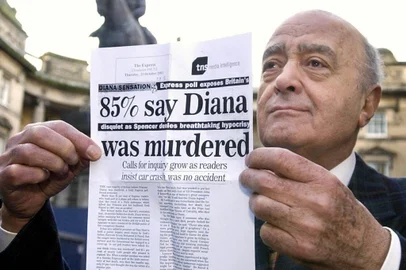 Mohamed Al Fayed holds up a piece of paper showing poll results as he leaves the Court of Session in Edinburgh, Monday Dec. 15, 2003, where a judge was asked to consider whether the crash which killed Diana, Princess of Wales and her lover Dodi Fayed was caused deliberately. The pair died when the Mercedes they were being driven in crashed in the Alma tunnel in Paris on August 31, 1997. (AP Photo/David Cheskin-pa)  ** UNITED KINGDOM OUT: MAGAZINES OUT: NO SALES: **<!-- NICAID(15529345) -->