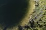 An aerial view of Crawford Lake as a team consisting of scientists from Carleton University and Brock University gather sediment layer samples from the lake bottom at the Crawford Lake Conservation Area near Milton, Ontario, Canada, April 12, 2023. The view under the surface of Crawford Lake tells a different story. Scientists believe the lake's exceptionally well-preserved sediment layers serve as a reference point for a proposed new geological chapter in the planet's history, defined by the considerable changes wrought by human activity: the Anthropocene. The International Commission on Stratigraphy's Anthropocene Working Group on July 11, 2023, named the lake as the embodiment of the proposed Anthropocene epoch. (Photo by Peter POWER / AFP)Editoria: SCILocal: MiltonIndexador: PETER POWERSecao: natural scienceFonte: AFPFotógrafo: STR<!-- NICAID(15479559) -->