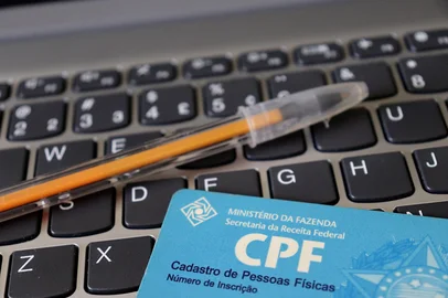 Brazilian CPF (Cadastro de Pessoa Fisica) identification card. Personal identification in Brazil. CPF card on a laptop keyboard. <!-- NICAID(16267859) -->
