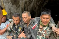 This handout photograph taken and released on September 5, 2026 via the Facebook page of Nepal Army shows security personnel carrying a Chinese national (2R) rescued from the Audit Tunnel 4 of the Upper Trishuli-1 Hydropower Project site in Nepal's Rasuwa district in the aftermath of flash floods. A Chinese national was pulled alive on September 5, from a tunnel buried by debris in Nepal after catastrophic flooding more than nine days ago, an army spokesman told AFP. (Photo by Handout / Nepal Army Facebook Page / AFP) / RESTRICTED TO EDITORIAL USE - MANDATORY CREDIT "AFP PHOTO / Nepal Army Facebook Page/ - " - HANDOUT - NO MARKETING NO ADVERTISING CAMPAIGNS - DISTRIBUTED AS A SERVICE TO CLIENTS<!-- NICAID(16360026) -->