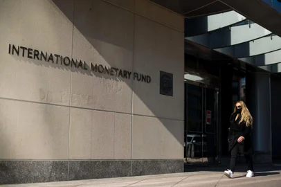 Uma mulher passa por um prédio da sede do Fundo Monetário Internacional (FMI) em Washington, DC em 5 de abril de 2021. - As reuniões anuais de primavera do Fundo Monetário Internacional (FMI) e do Grupo Banco Mundial serão realizadas virtualmente de 5 a abril 11, 2021. (Foto de MANDEL NGAN / AFP)<!-- NICAID(14751127) -->