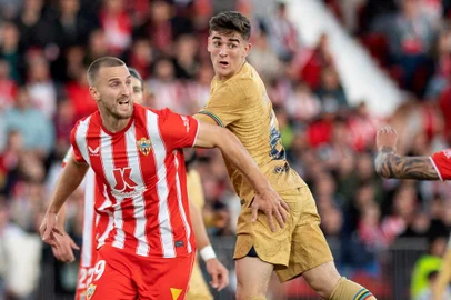 Barcelona's Spanish midfielder Gavi (C) fights for the ball with Almeria's Brazilian defender Rodrigo Ely (L) and Almeria's Spanish defender Chumi during the Spanish League football match between UD Almeria and FC Barcelona at the Municipal Stadium of the Mediterranean Games in Almeria, on February 26, 2023. (Photo by JORGE GUERRERO / AFP)Editoria: SPOLocal: AlmeríaIndexador: JORGE GUERREROSecao: soccerFonte: AFPFotógrafo: STR<!-- NICAID(15496336) -->