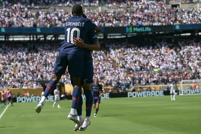 Paris Saint-Germain's French forward #10 Ousmane Dembele (L) celebrates with teammate French midfielder #14 Desire Doue after scoring his team's second goal during the FIFA Club World Cup 2025 semifinal football match between France's Paris Saint-Germain and Spain's Real Madrid at the MetLife stadium in East Rutherford, New Jersey on July 9, 2025. (Photo by JUAN MABROMATA / AFP)<!-- NICAID(16077037) -->