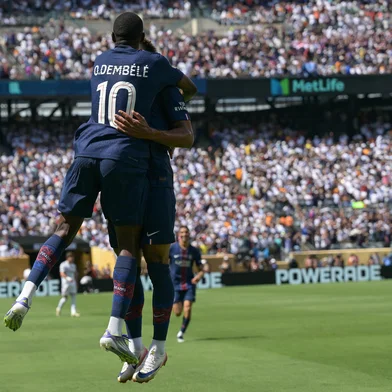 Paris Saint-Germain's French forward #10 Ousmane Dembele (L) celebrates with teammate French midfielder #14 Desire Doue after scoring his team's second goal during the FIFA Club World Cup 2025 semifinal football match between France's Paris Saint-Germain and Spain's Real Madrid at the MetLife stadium in East Rutherford, New Jersey on July 9, 2025. (Photo by JUAN MABROMATA / AFP)<!-- NICAID(16077037) -->