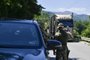 NATO soldiers greet a truck driver near the town of Zubin Potok on August 1, 2022. - Serbs in North Kosovo removed barricades on August 1 that closed two crossings along the border with Serbia after authorities in Pristina postponed the implementation of new travel measures that sparked tensions. Trucks and barriers were being cleared from the roads, according to an AFP reporter, hours after a string of shootings and air raid sirens in northern Kosovo sent tensions soaring in the disputed territory home to both Serbs and ethnic Albanians. (Photo by Armend NIMANI / AFP)<!-- NICAID(15164668) -->