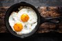fried eggs in black pan<!-- NICAID(15673841) -->