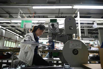 This photo taken on June 10, 2025 shows a worker packing bathroom fittings in a factory of the Taiwanese-owned LCM Group, a contract manufacturer for big European and American brands, which produces items ranging from automotive parts to household fittings and smart door locks, in Kunshan, in Chinas eastern Jiangsu province. Bustling Taipei-style shopping streets, majestic temples to the island's deities and thriving factories dot the eastern Chinese city of Kunshan, for years a hub for Taiwanese businesses. But now those firms are feeling the strain from cross-Strait tensions that have stoked safety fears among companies. Taiwanese entrepreneurs -- known as "Taishang" in Mandarin -- poured billions into mainland China since ties began improving in the 1990s, playing an important role in its rise to become the world's second-largest economy. (Photo by GREG BAKER / AFP) / To go with 'CHINA-TAIWAN-ECONOMY-POLITICS, FOCUS' by Adrien Simorre with Amber Wang<!-- NICAID(16065292) -->