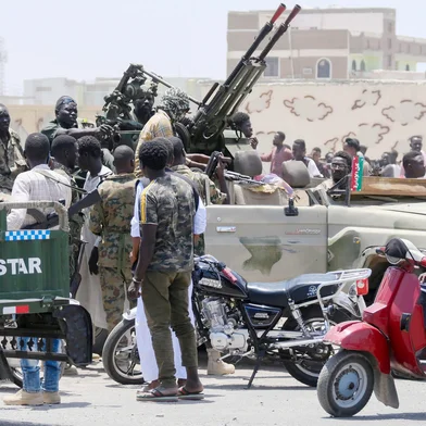 Sudanese greet army soldiers, loyal to army chief Abdel Fattah al-Burhan, in the Red Sea city of Port Sudan on April 16, 2023. - Battling fighters in Sudan said they had agreed to an hours-long humanitarian pause, including to evacuate wounded, on the second day of raging urban battles that killed more than 50 civilians including three UN staff and sparking international outcry. (Photo by AFP)Editoria: WARLocal: Port SudanIndexador: -Secao: armed conflictFonte: AFPFotógrafo: STR<!-- NICAID(15404095) -->