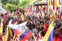 This handout picture released by the Venezuelan Presidency shows Venezuelan President Nicolas Maduro (R) waving to supporters during a political rally in Caracas on April 13, 2024. Venezuelan President Nicolás Maduro proposed on Saturday a constitutional reform to establish life imprisonment and political disqualifications for life for corruption and treason crimes in the South American country, where the highest penalty is 30 years in prison. (Photo by ZURIMAC CAMPOS / Venezuelan Presidency / AFP) / RESTRICTED TO EDITORIAL USE - MANDATORY CREDIT "AFP PHOTO / VENEZUELAN PRESIDENCY - Zurimar CAMPOS" - NO MARKETING - NO ADVERTISING CAMPAIGNS - DISTRIBUTED AS A SERVICE TO CLIENTS<!-- NICAID(15741183) -->