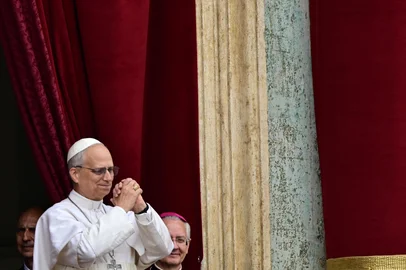 Pope Leo XIV gestures after delivering the Regina Caeli prayer from the main central loggia of St Peter's basilica in The Vatican, on May 11, 2025. (Photo by Tiziana FABI / AFP)<!-- NICAID(16034706) -->