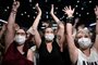 People attend a concert of French DJ Etienne de Crecy and pop band Indochine, aimed at scientifically testing the safety level toward the Covid-19 infection and the possibilities of reopening live events amidst the pandemic, at the AccorHotels Arena in Paris on May 29, 2021. (Photo by STEPHANE DE SAKUTIN / AFP)<!-- NICAID(14796142) -->